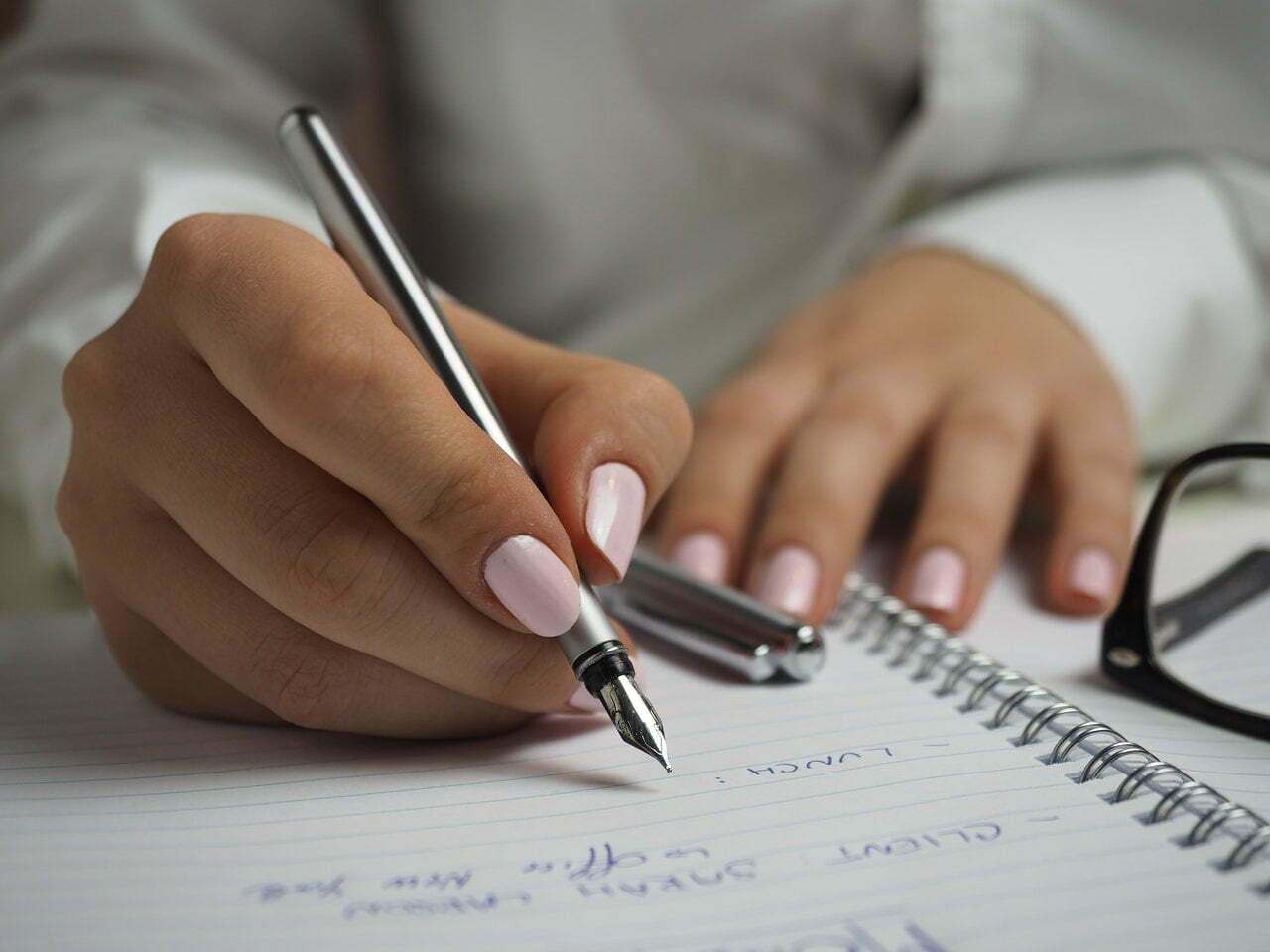 a hand holding a pen