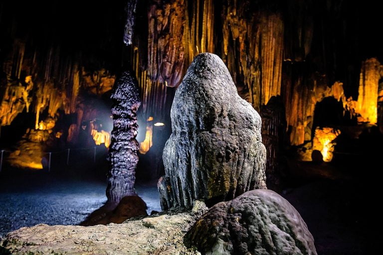 a group of rocks with fire in the background