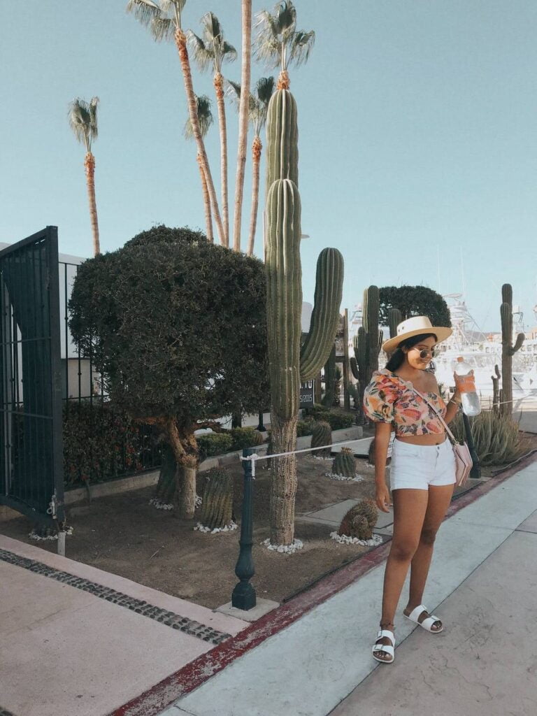 a person wearing a helmet and walking on a sidewalk