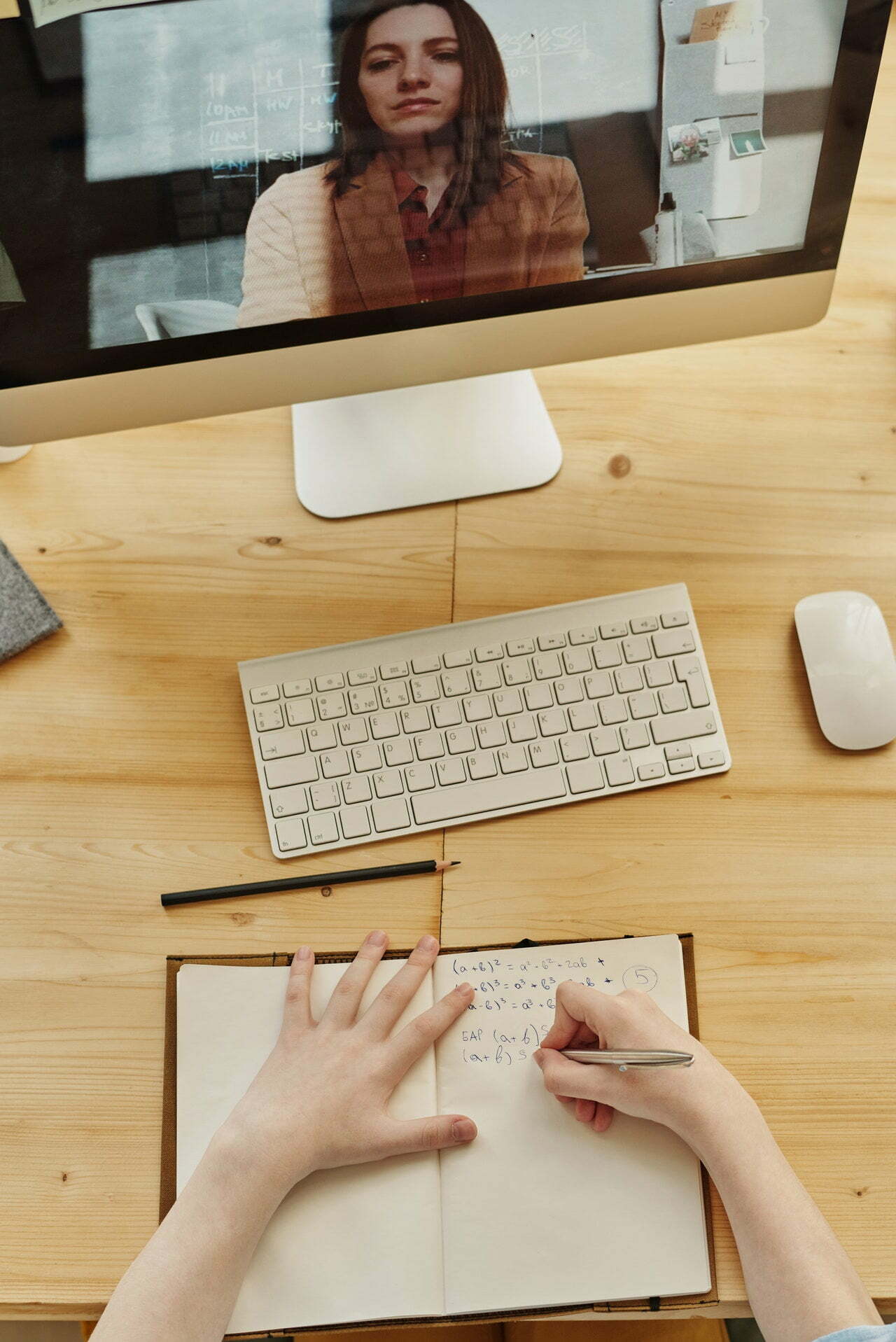 a person's hands on a table with a keyboard and a mouse