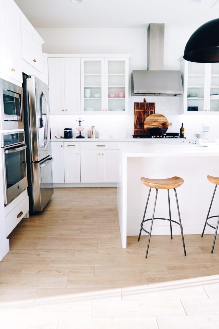 a kitchen with a stool and a stool