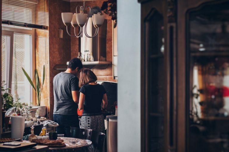 a group of people standing in a kitchen