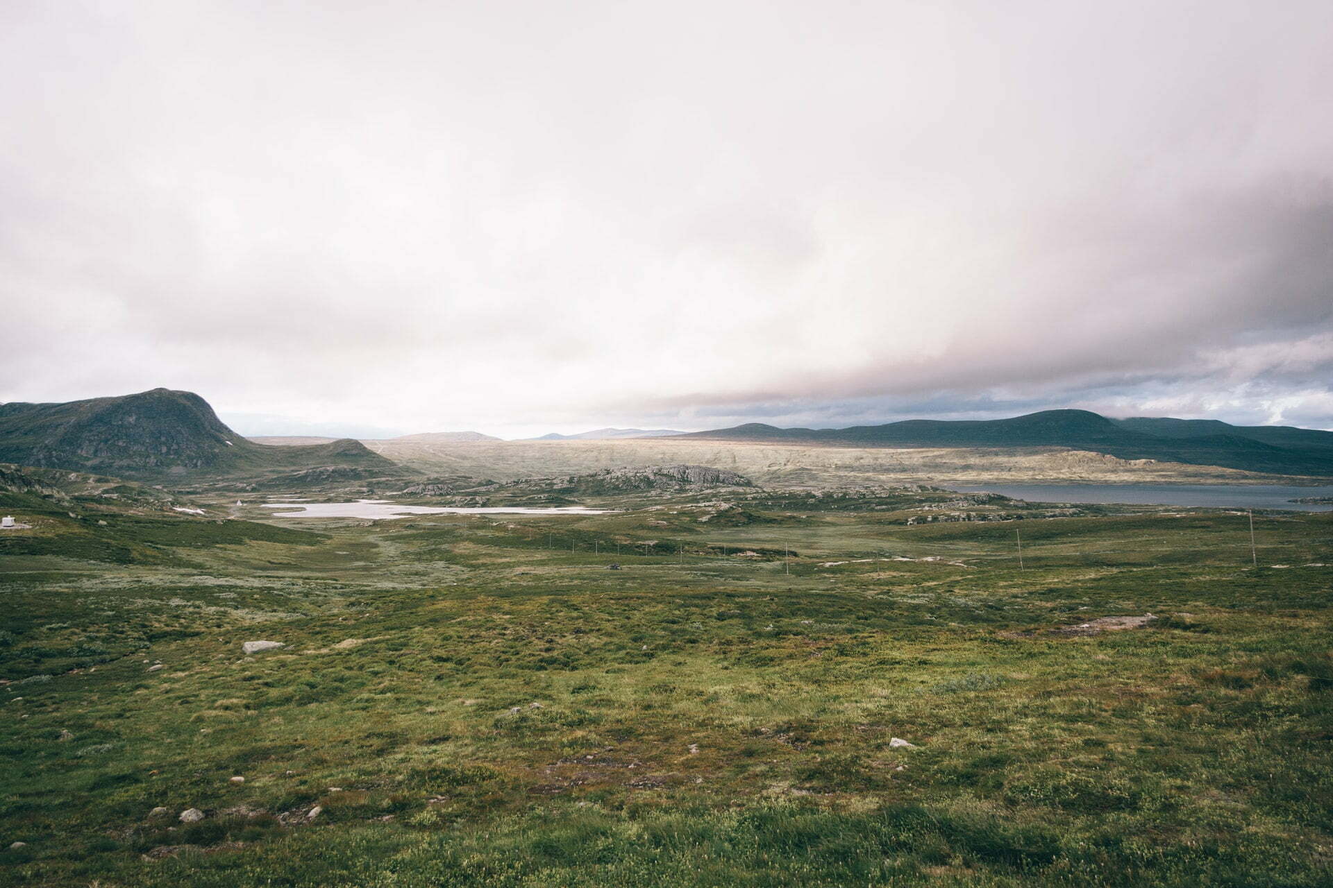 a grassy area with hills in the background