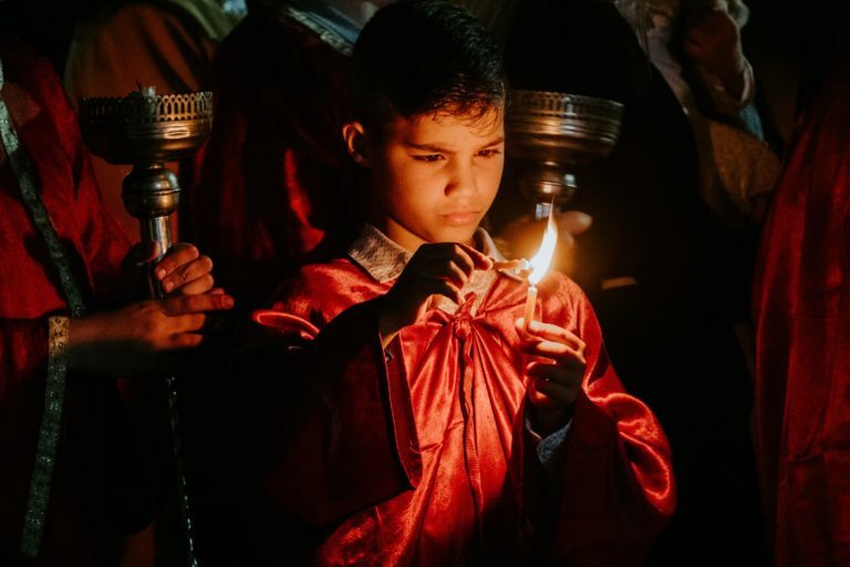 a person holding a lit candle