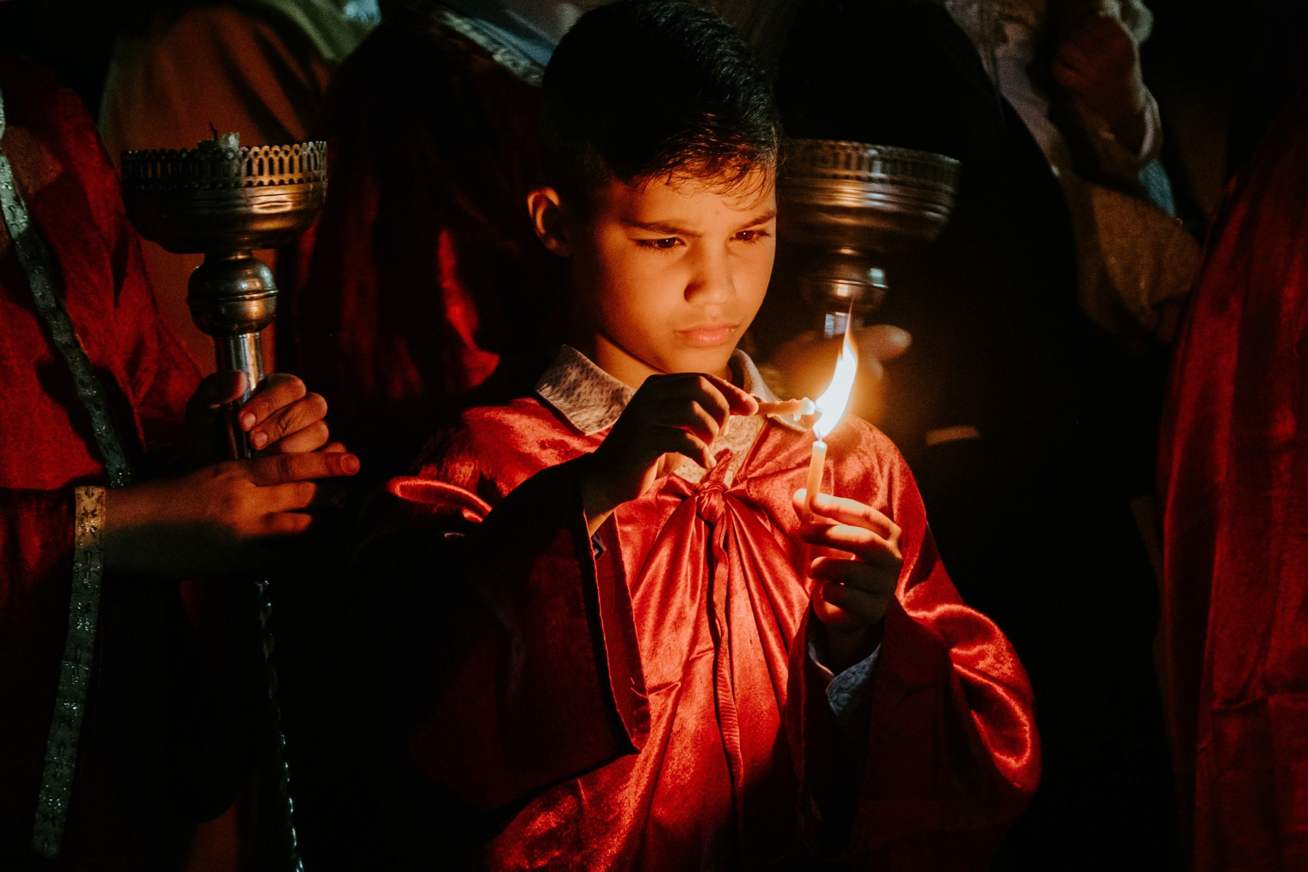 a person holding a lit candle