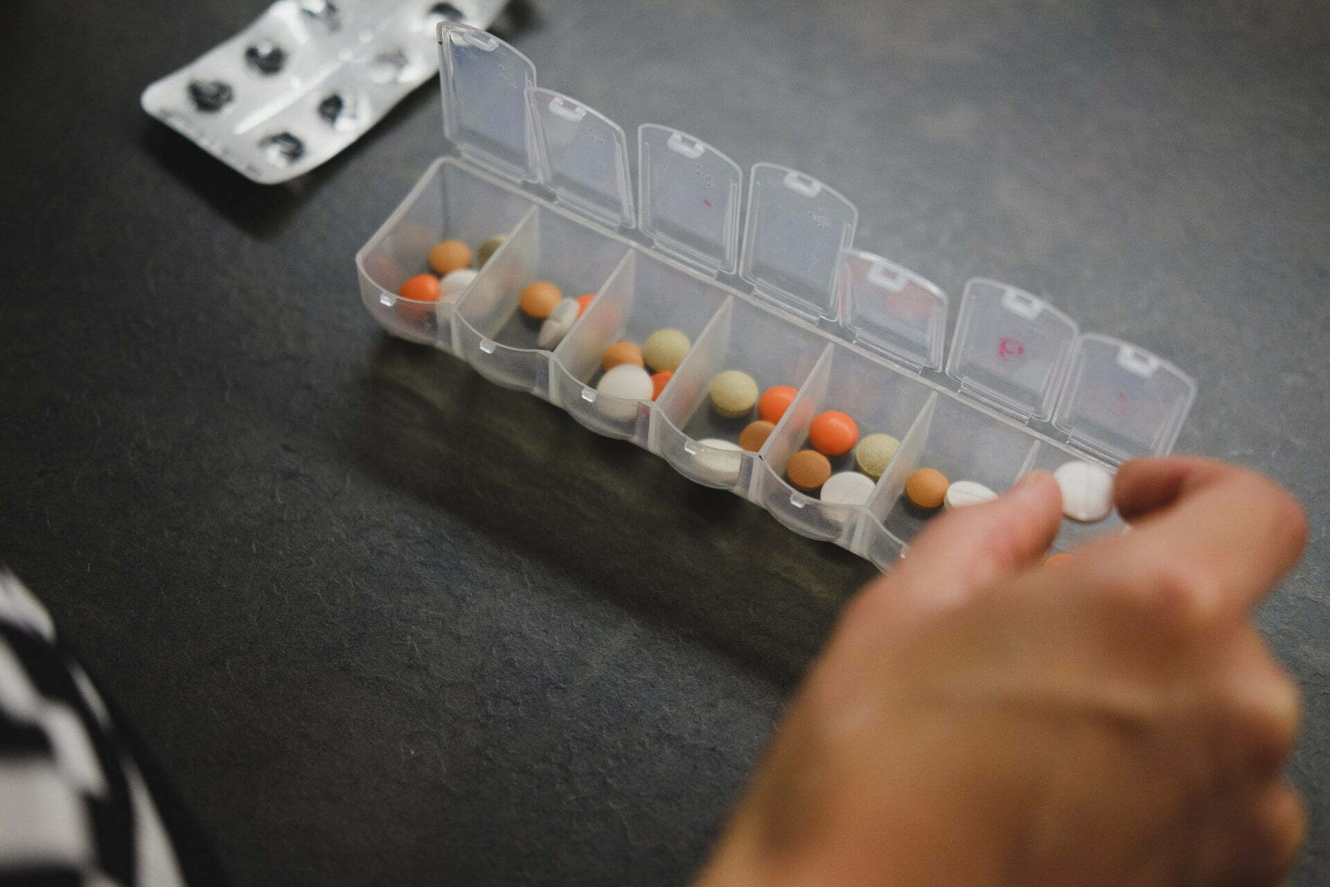 a hand holding a plastic model of a house made of plastic