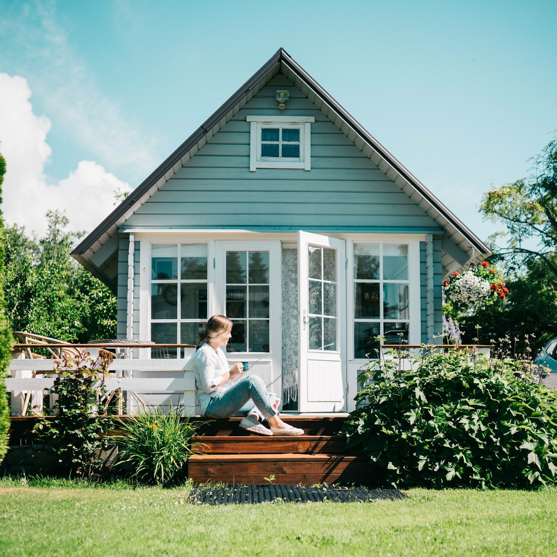 a person sitting on a log in front of a house