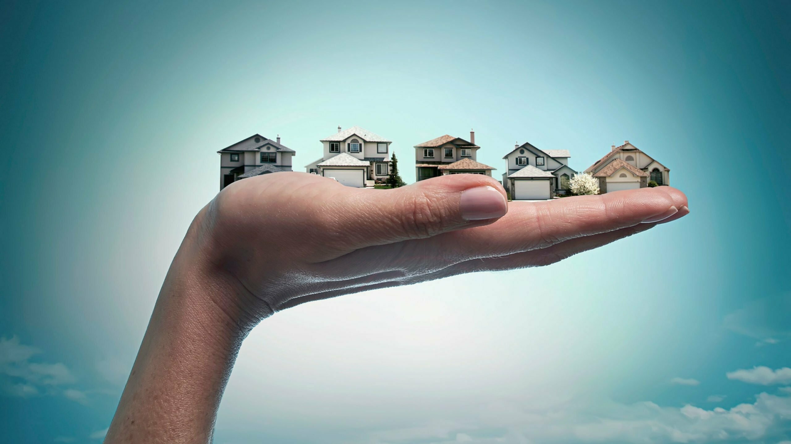 a hand holding a few buildings