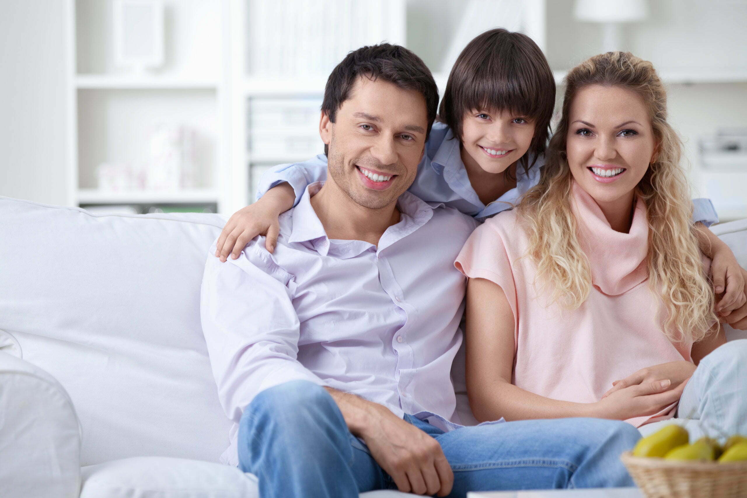 a family sitting on a couch