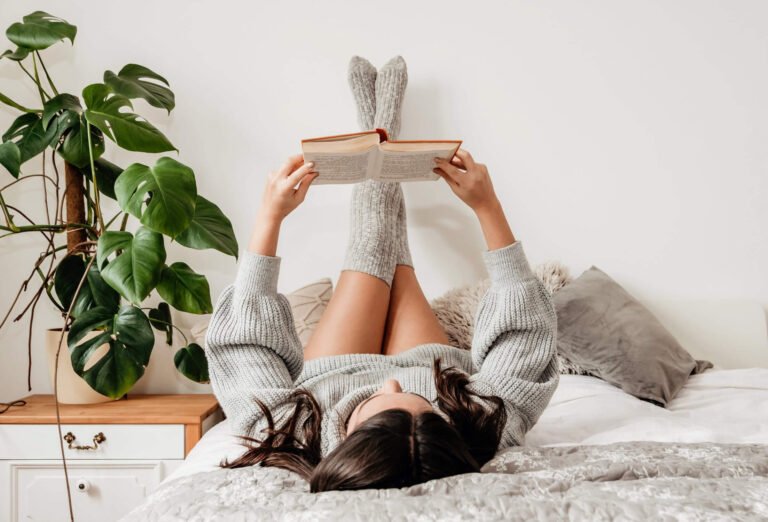 a person lying on a bed with a box on the head