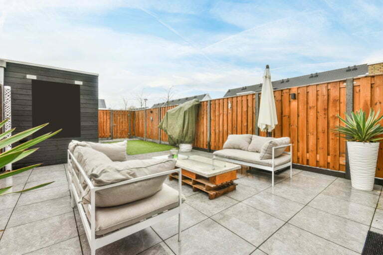 a patio with furniture and a fireplace